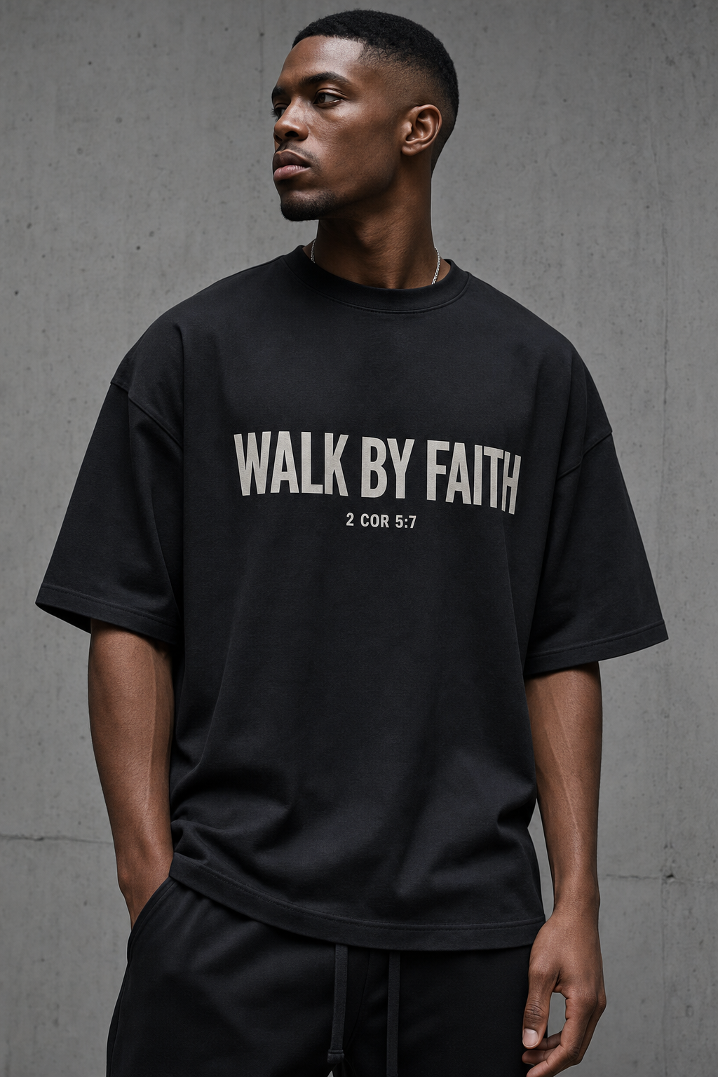 Walk By Faith Tee - model wearing black tee with bold cream chest print