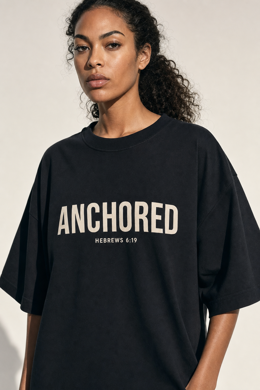Anchored Tee - model wearing black tee with bold cream chest print