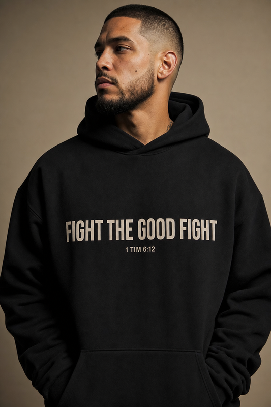 Fight The Good Fight Hoodie - model wearing black hoodie with bold cream chest print